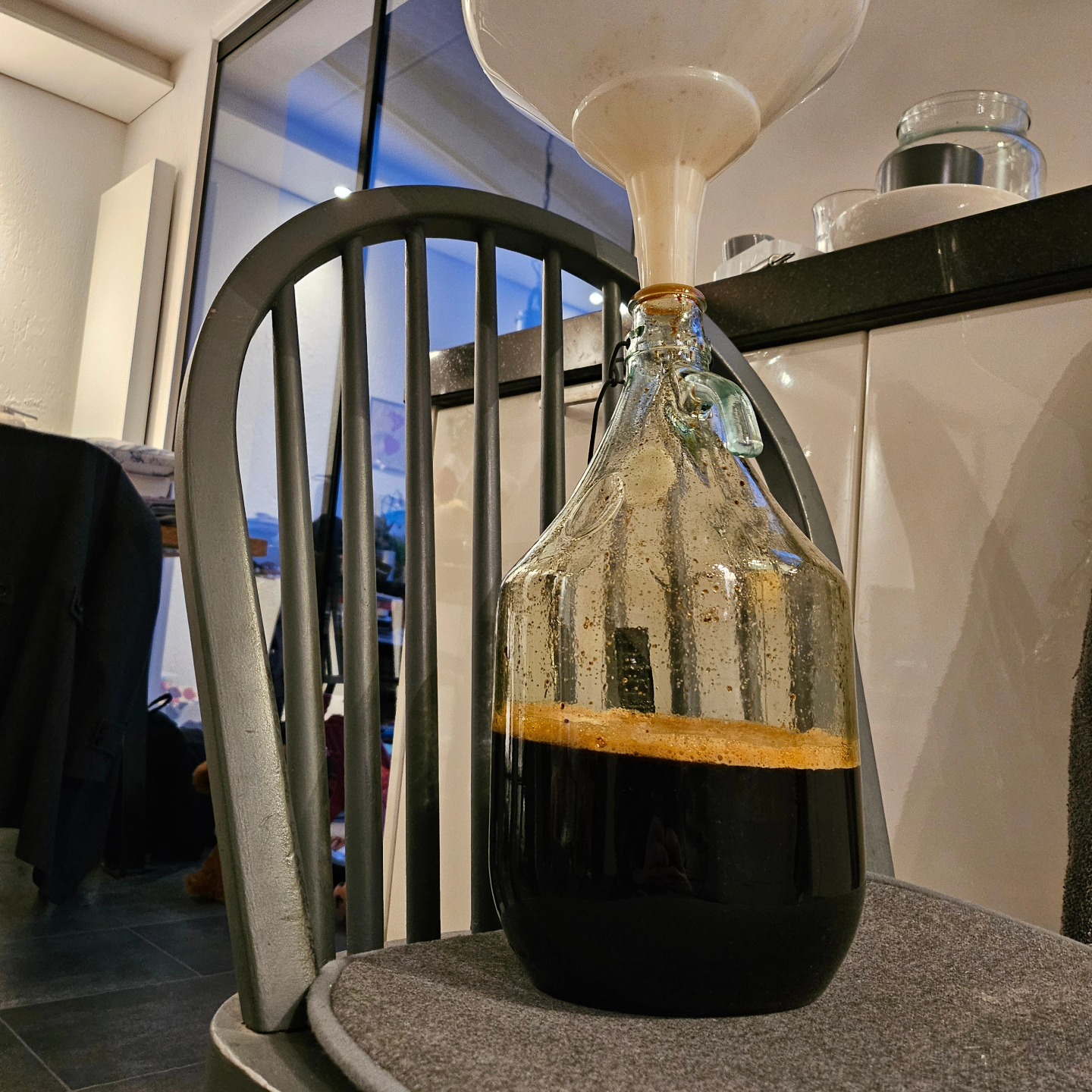 Dark stout being filtered into carboy