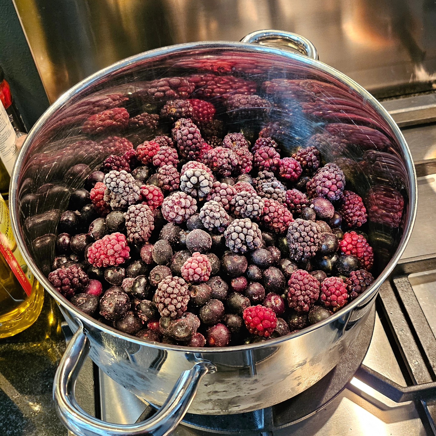 Frozen berries in a steel pot ready for brewing