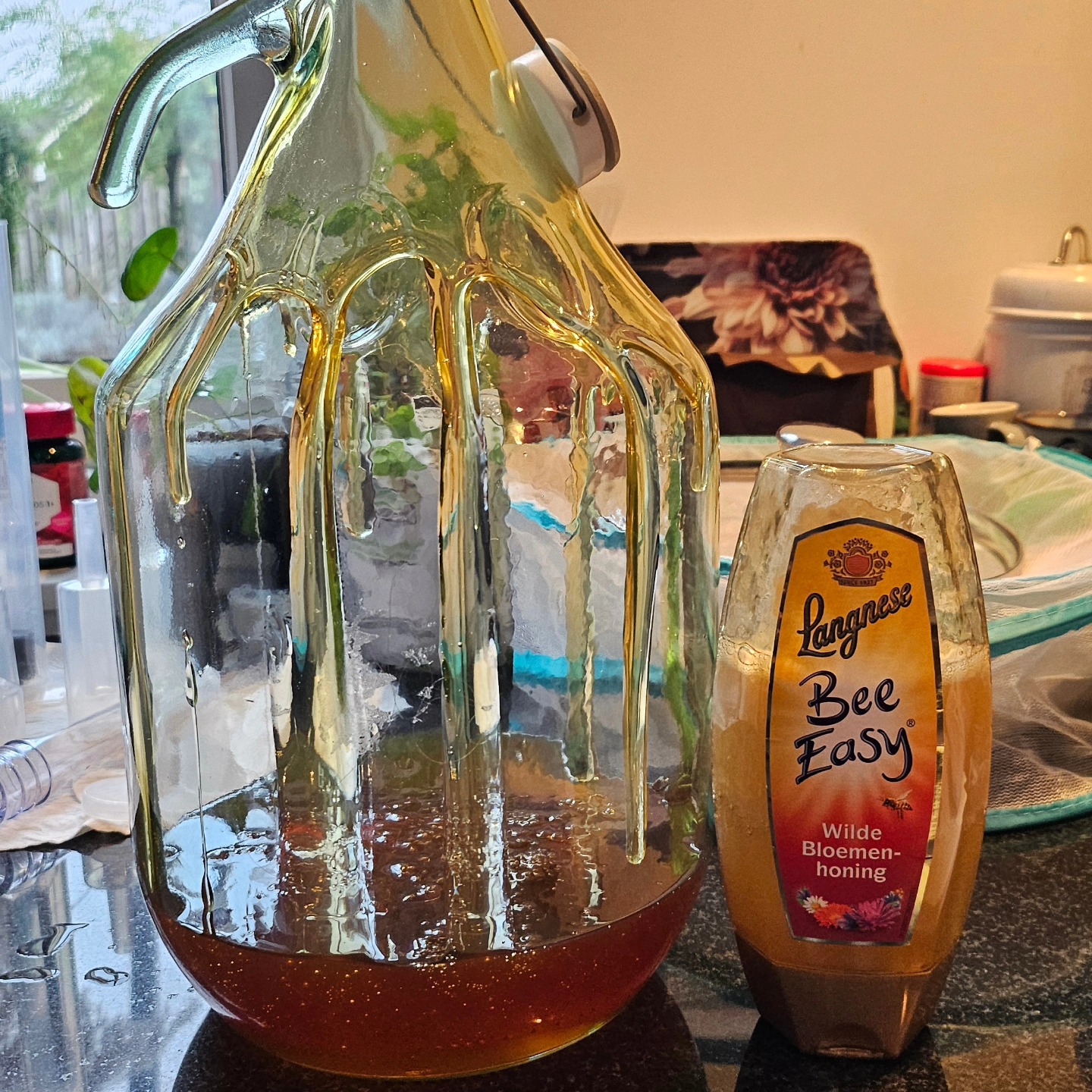 Honey dripping from a jug into brewing vessel